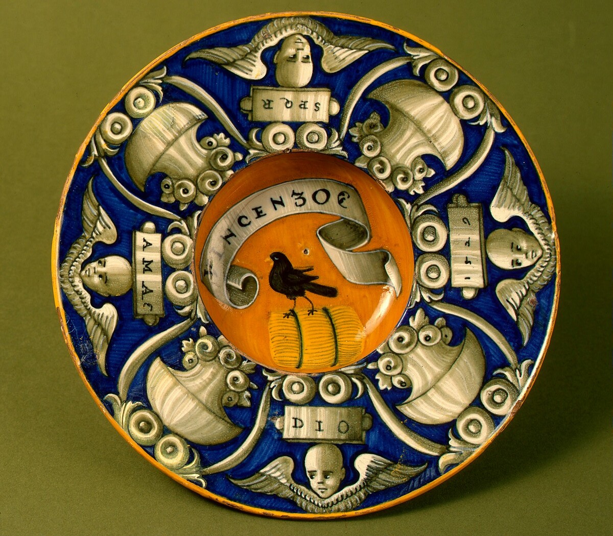 Broad-rimmed bowl with border of urns and cherubs' heads; in the center, device of a bird standing on a bundle with the inscription VINCENZO by Urbino district 16th Century