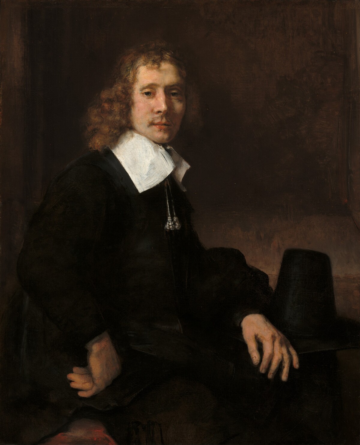 A Young Man Seated at a Table (possibly Govaert Flinck) by Rembrandt van Rijn