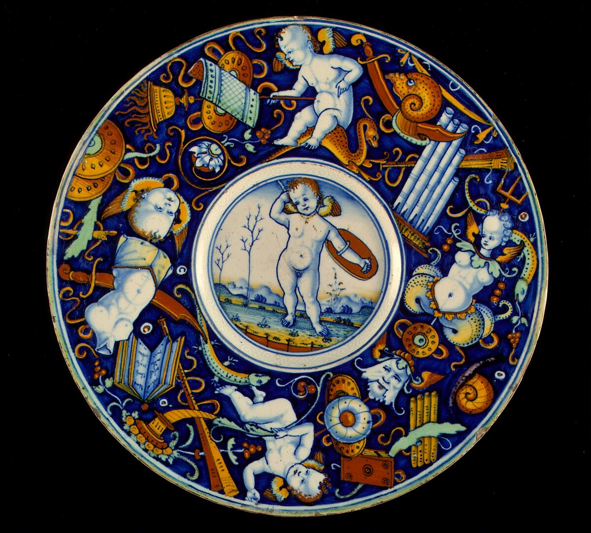 Plate with border of putti and trophies amid grotesques; in the center, a winged putto standing, armed, in a landscape by Probably Urbino district or Venetian 16th Century