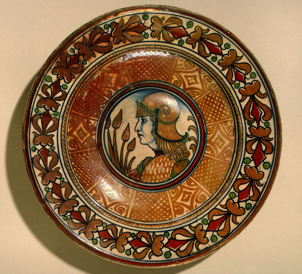 Plate with running plant border and geometric panels on well; in the center, profile bust of a man in armor by Deruta or Possibly Gubbio 16th Century
