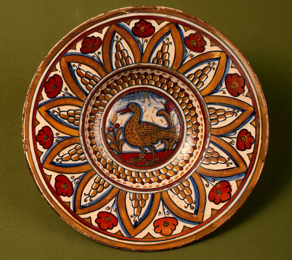 Plate with border of rounded hills within pointed arches with flowers between them; in the center, a wading bird between stylized plants by Deruta or Possibly Gubbio 16th Century