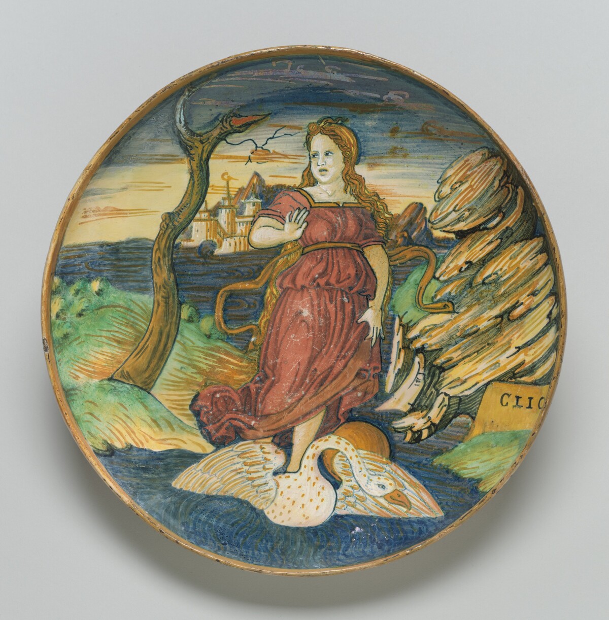 Shallow bowl on low foot with the muse Clio riding on a swan through a watery landscape by Probably painted and lustered in the workshop of Maestro Giorgio Andreoli of Gubbio