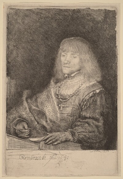 Man at a Desk Wearing a Cross and Chain