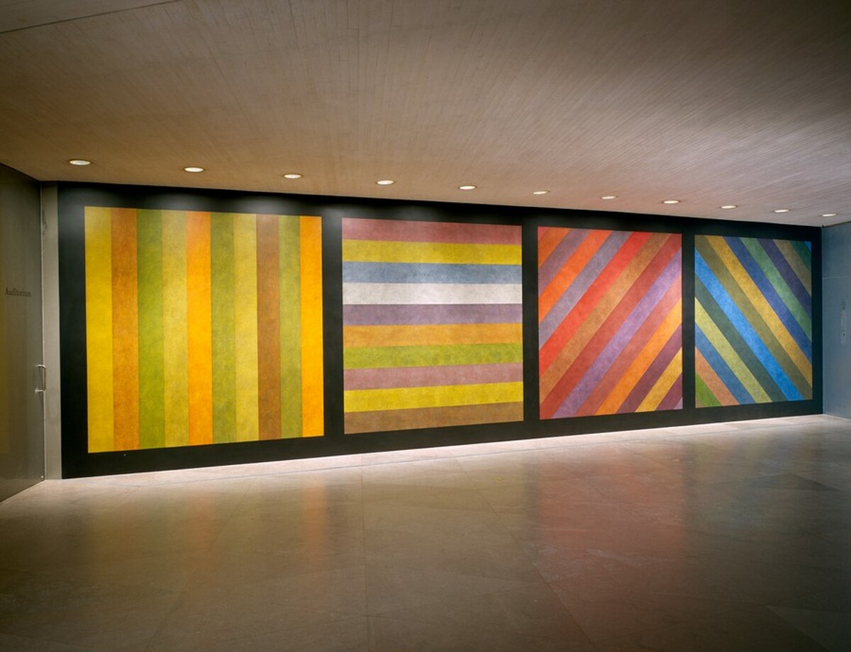 Wall Drawing No. 681 C / A wall divided vertically into four equal squares separated and bordered by black bands. Within each square, bands in one of four directions, each with color ink washes superimposed. by Sol LeWitt